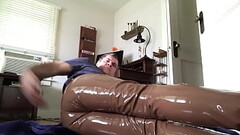 Man masturbating in his brown leather pants and plastic underwear filled with lube Thumb